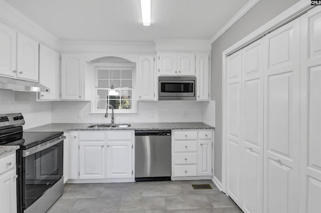 1490 Shiver Pond Rd, Camden, SC 29020 - kitchen featuring appliances with stainless steel finishes, a sink, under cabinet range hood, light stone countertops, and ornamental molding