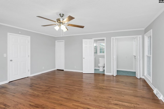 empty room featuring dark wood-type flooring, ceiling fan, crown molding, and a textured ceiling