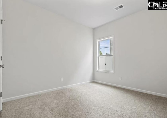 carpeted empty room featuring visible vents and baseboards