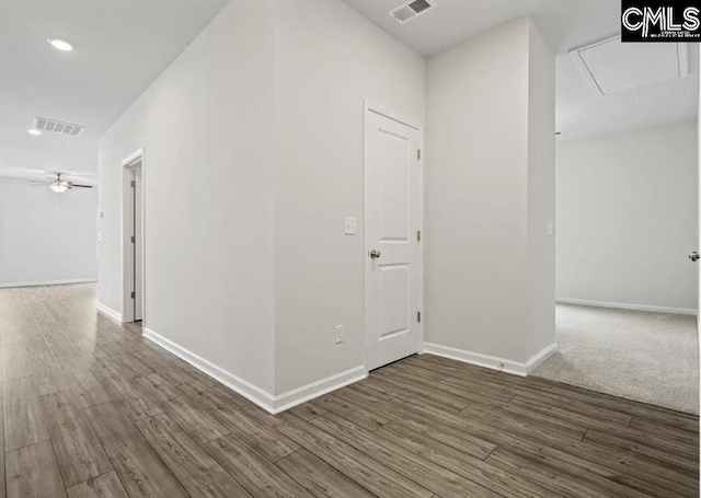 corridor with hardwood / wood-style floors