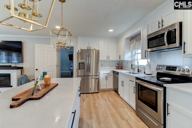 kitchen featuring sink, white cabinets, stainless steel appliances, and backsplash