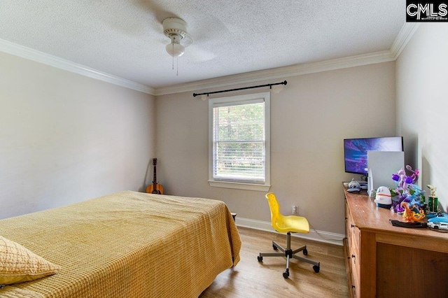 bedroom featuring ceiling fan, crown molding, wood-type flooring, and a textured ceiling