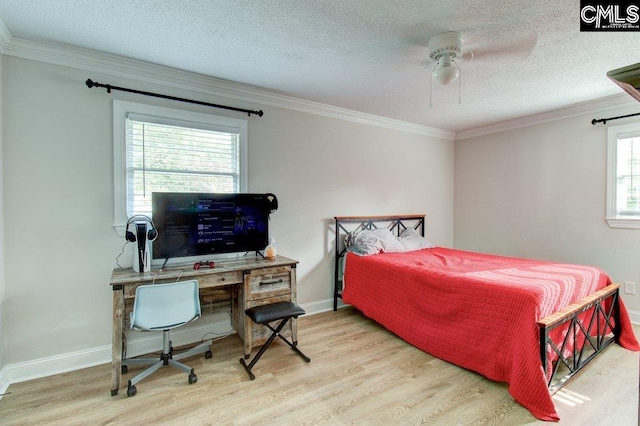 bedroom featuring multiple windows, light hardwood / wood-style floors, and ceiling fan