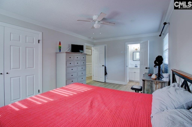 bedroom featuring ceiling fan, a textured ceiling, connected bathroom, light hardwood / wood-style flooring, and crown molding