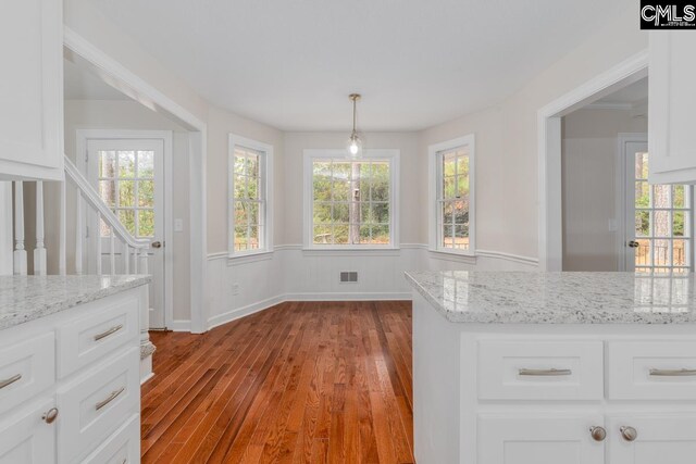 unfurnished dining area featuring light wood-type flooring