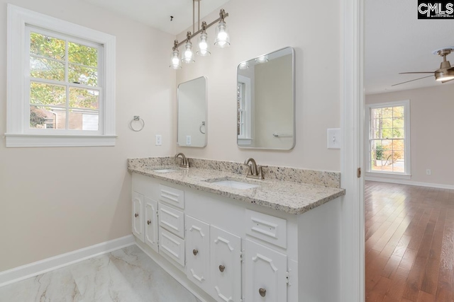 bathroom featuring vanity, ceiling fan, and wood-type flooring