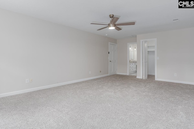 unfurnished bedroom featuring light carpet, ensuite bathroom, and ceiling fan