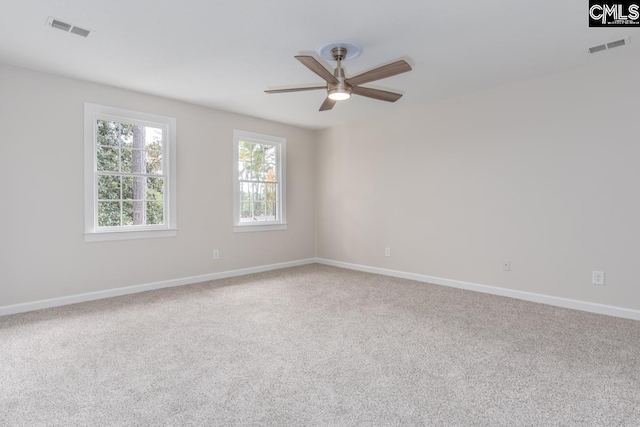 carpeted spare room featuring ceiling fan