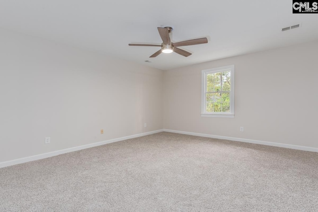 carpeted spare room featuring ceiling fan