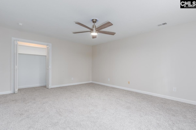 unfurnished bedroom with light colored carpet, a closet, and ceiling fan