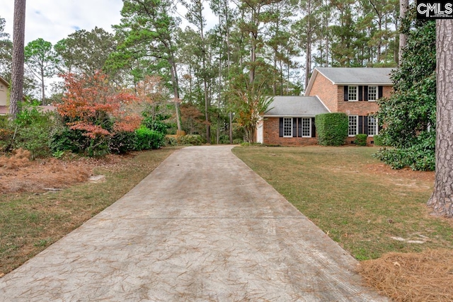 colonial home with a front lawn