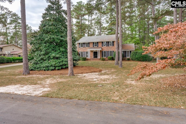 colonial home with a front yard