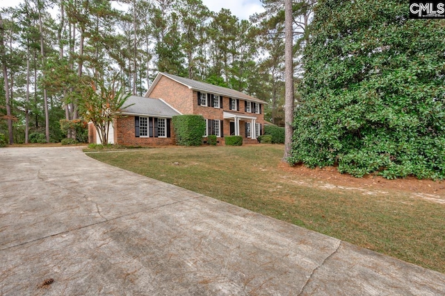 colonial-style house with a front lawn