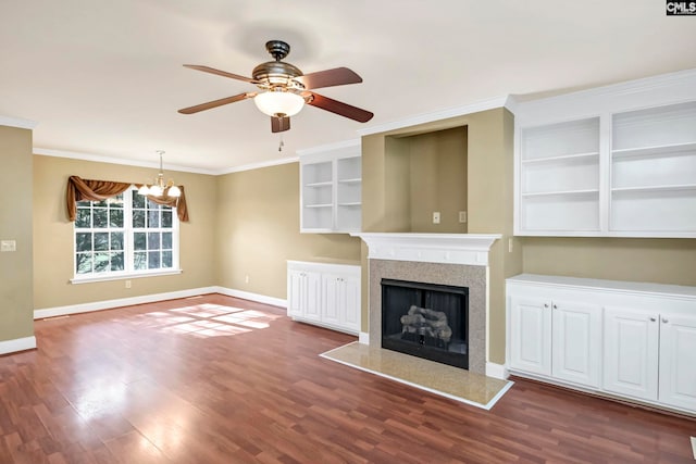 unfurnished living room featuring dark wood-type flooring, ceiling fan with notable chandelier, and crown molding