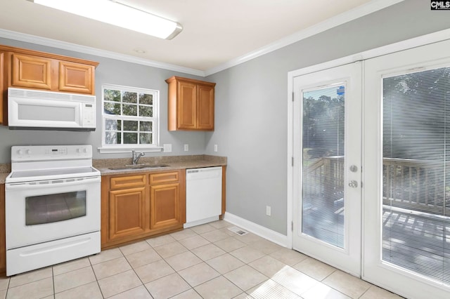 kitchen featuring french doors, crown molding, light tile patterned floors, sink, and white appliances