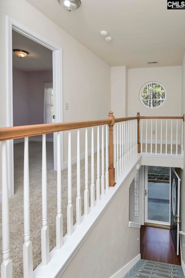 stairway featuring wood-type flooring