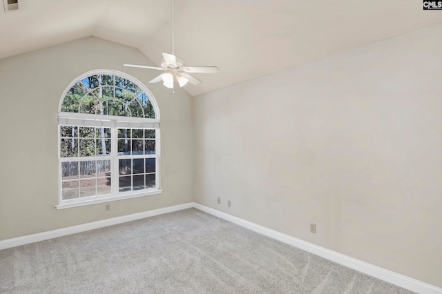 spare room featuring lofted ceiling, carpet flooring, and ceiling fan