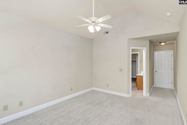 unfurnished bedroom featuring ceiling fan, vaulted ceiling, and light colored carpet