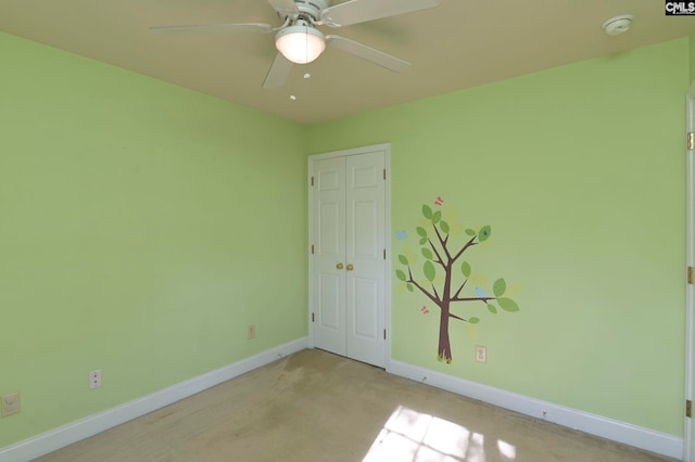 spare room with ceiling fan and light carpet