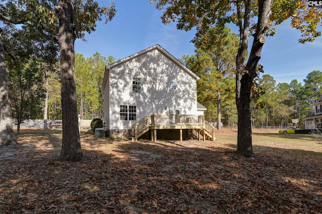 back of house with central AC unit and a deck