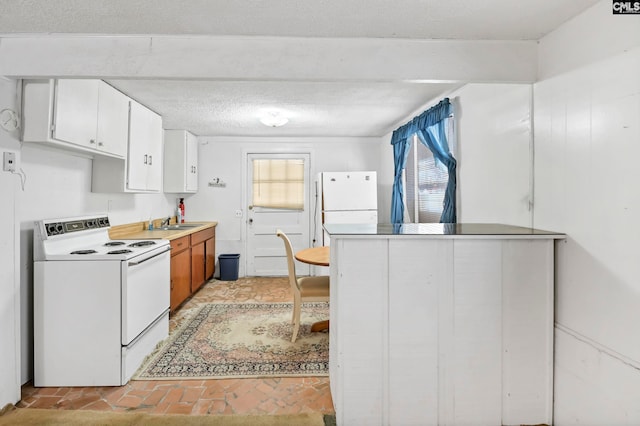 kitchen featuring white cabinets, a textured ceiling, sink, and white appliances