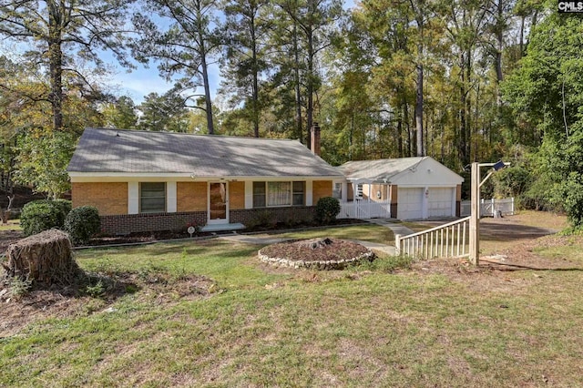 ranch-style house featuring a garage, a front yard, and covered porch