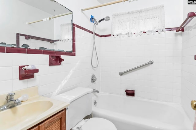 full bathroom with toilet, vanity, and tiled shower / bath