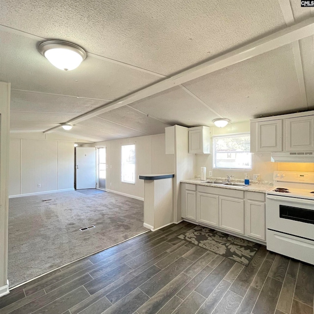 kitchen with white cabinetry, a wealth of natural light, white electric range, and dark colored carpet