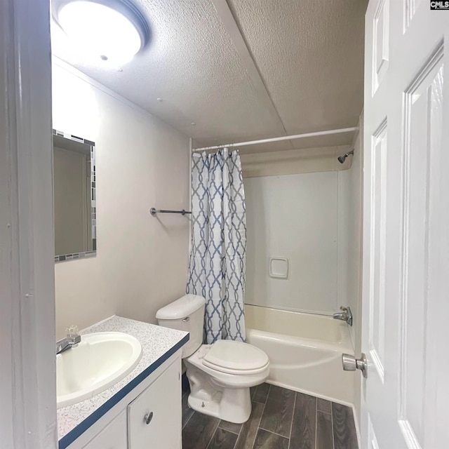 full bathroom with hardwood / wood-style flooring, a textured ceiling, shower / bathtub combination with curtain, vanity, and toilet