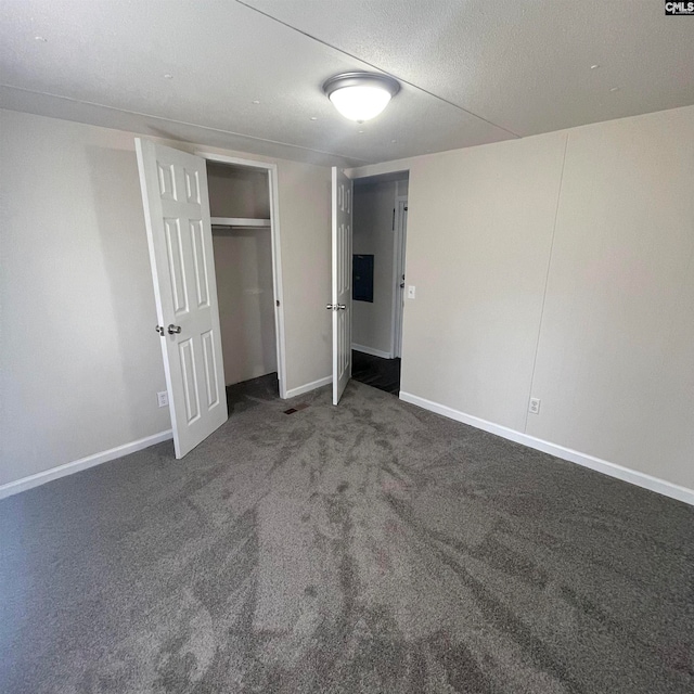 unfurnished bedroom featuring dark colored carpet