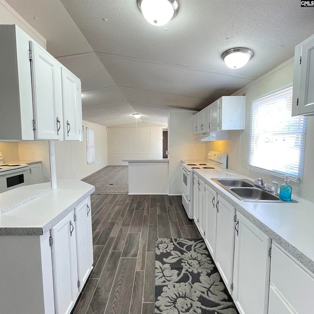 kitchen featuring dark wood-type flooring, vaulted ceiling, white cabinetry, and white range with electric stovetop