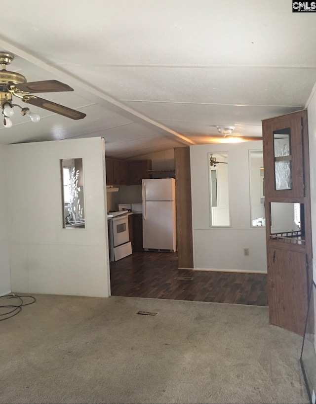 interior space featuring lofted ceiling, ceiling fan, and dark hardwood / wood-style flooring