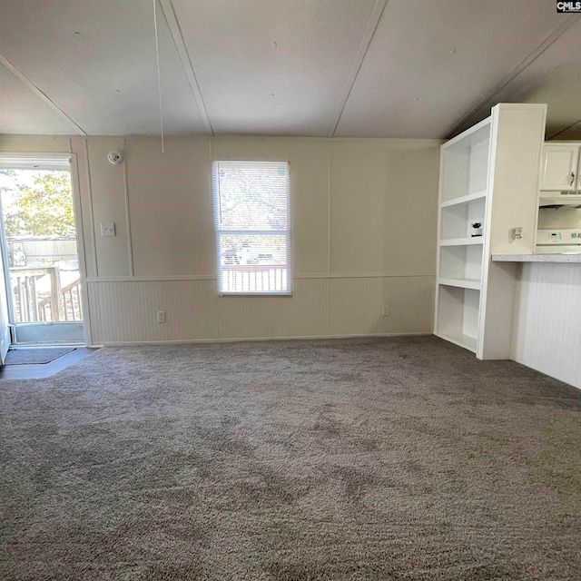 unfurnished living room featuring a healthy amount of sunlight and carpet floors