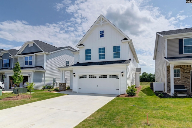 view of front of home featuring a garage, cooling unit, and a front yard