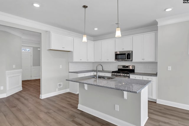 kitchen with white cabinetry, light hardwood / wood-style floors, appliances with stainless steel finishes, and sink