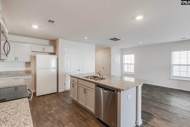 kitchen with white appliances, dark hardwood / wood-style floors, sink, and a wealth of natural light