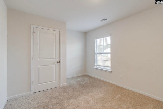 unfurnished room with light carpet