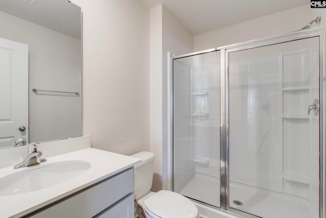 bathroom with vanity, toilet, and an enclosed shower