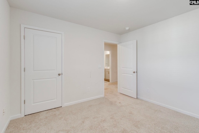 unfurnished bedroom featuring light carpet