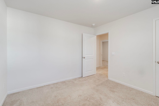 unfurnished room with light carpet