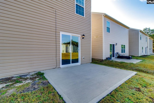 rear view of property featuring a yard and a patio