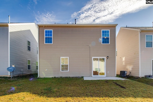 rear view of house featuring central AC, a yard, and a patio area