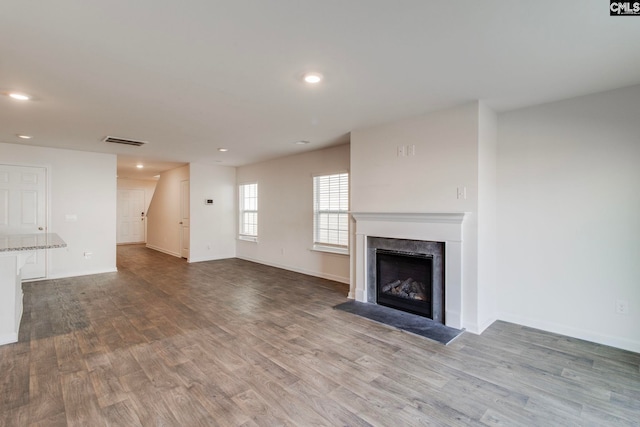 unfurnished living room with wood-type flooring