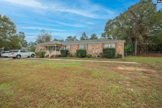 single story home with a porch and a front yard