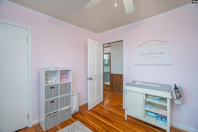 bedroom with hardwood / wood-style flooring, ceiling fan, and crown molding