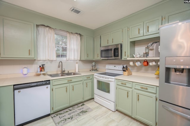 kitchen with ornamental molding, stainless steel appliances, a textured ceiling, and sink