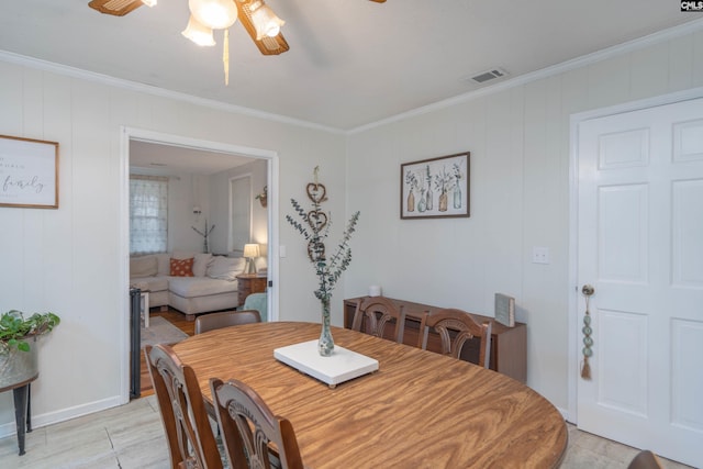 dining area with ceiling fan and crown molding