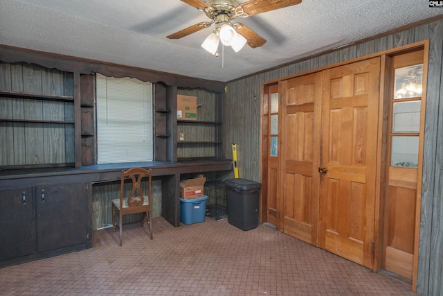 office area with ornamental molding, light carpet, a textured ceiling, and ceiling fan