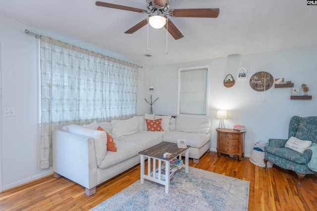 living room with hardwood / wood-style flooring and ceiling fan