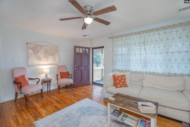 living room featuring ceiling fan and light wood-type flooring